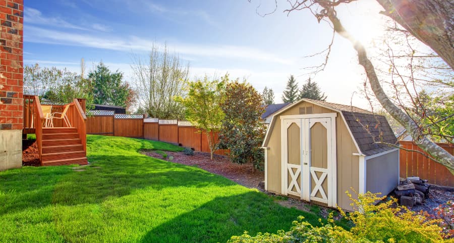 Fenced backyard with storage shed in York